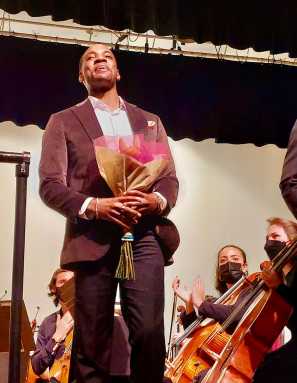 Christian Mark Gibbs, is pictured after a performance, and receiving the Choral Society 2022 Silver Jubilee Award in honor of John Castellini. The annual award is given to a distinguished School of Music graduate of Queens College, who, as an undergraduate, was associated with performances of the Choral Society.