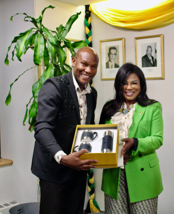 Glenroy March receives a Jamaica 60 Independence Anniversary memorabilia from Consular General Alsion Roach Wilson, at the launch of the author's fashion book “The Allure,” at the Jamaica Consulate in Manhattan, on March 10.