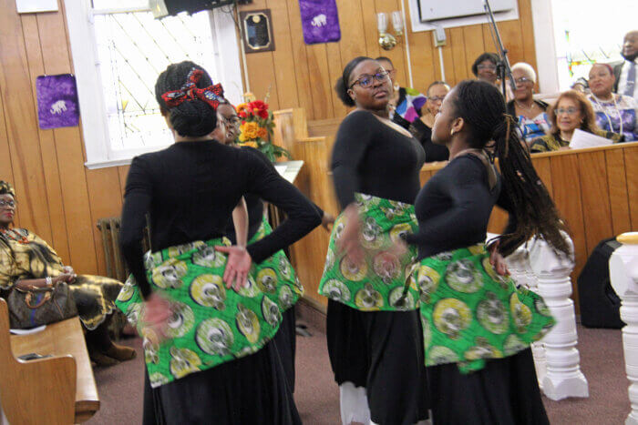 Young adults perform a liturgical dance.