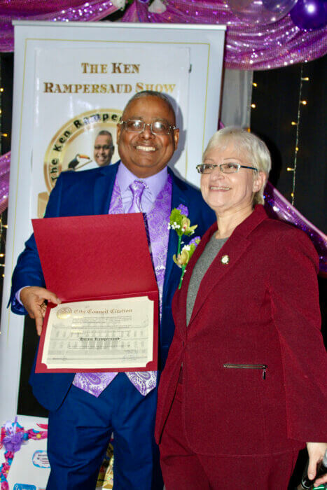 Councilwoman Lynn Schulman presents a citation to Ken Rampersaud, producer of the Int. Women's Day 2023 Awards during an inspiring honors event at Code Lounge, Richmond Hill, Queens.