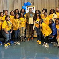 Senate Kevin Parker, center, is surrounded by members of Sigma Gamma Rho Sorority at their recent annual Youth Symposium. 