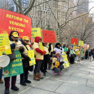 Vendors in a line around City Hall with signs in six languages reading “Cut the Red Tape” and “Street Vendors are Small Businesses.”