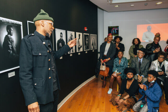 Malik Yusef Cumbo speaks to exhibition viewers on opening night of CCCADI's Rhythm, Bass and Place exhibition on March 17, 2023.