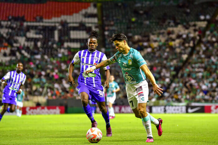 Victor Davila, scorer of two goals for Club Leon, on the right, battles for possession against Elvynes Dejean of Violette AC.