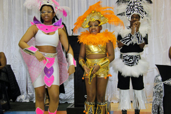 Masqueraders from Mas Productions Unlimited display their costumes.