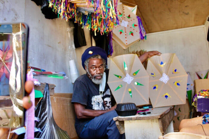 Maurice Prince displays some of his kites from a large collection ready for celebrants to be flown on the Seawall.