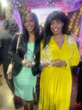 Dr. Veronica Wiltshire and medical information technologist, Cloyette Harris Stoute proudly display the Ken Rampersaud Show International Women's Day 2023 plaques at a recently held Awards Gala at Code Lounge in Queens.