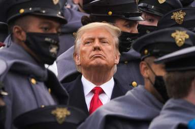 FIlE - Surrounded by Army cadets, President Donald Trump watches the first half of the 121st Army-Navy Football Game in Michie Stadium at the United States Military Academy, Saturday, Dec. 12, 2020, in West Point, N.Y.