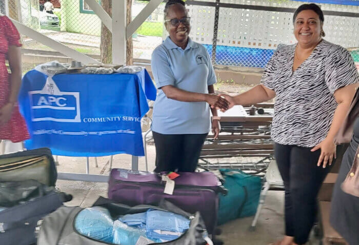 President and CEO, Janice Emanuel McLean. Ph.D., ND, left, during a presentation of equipment and supplies to Dr. Sharma-RHO.