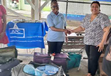 President and CEO, Janice Emanuel McLean. Ph.D., ND, left, during a presentation of equipment and supplies to Dr. Sharma-RHO.