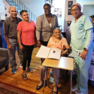 Doris Fordyce seated with her son Gladwyn and his wife Evelyn (left), Sen. Persaud, center, and Ms. Fordyce's daughter, Paula.