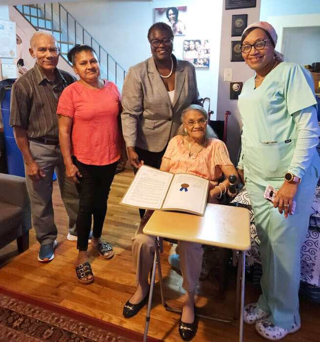 Doris Fordyce seated with her son Gladwyn and his wife Evelyn (left), Sen. Persaud, center, and Ms. Fordyce's daughter, Paula.