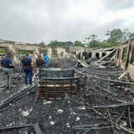 In this photo provided by Guyana's Department of Public Information, the dormitory of a secondary school is burned in Mahdia, Guyana, Monday, May 22, 2023. A nighttime fire raced through the dormitory early Monday, killing at least 19 students and injuring several others, authorities said.
