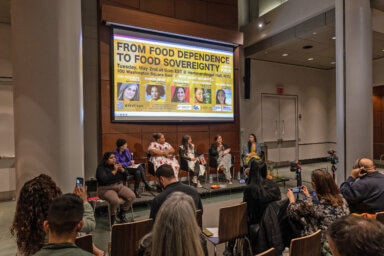 Panelists, moderator and sign language interpreter seated on stage during the panel, From Food Dependence to Food Sovereignty, held at NYU on May 2. From left: Interpreter, journalist and moderator Amy Goodman, Sommer Sibilly-Brown of the U.S. Virgin Islands, Crystal Diaz of Puerto Rico, Ursula Herrera of Guahan (Indigenous name for U.S. territory of Guam) and Rica Dela Cruz of the Northern Marianas (American Samoa). 