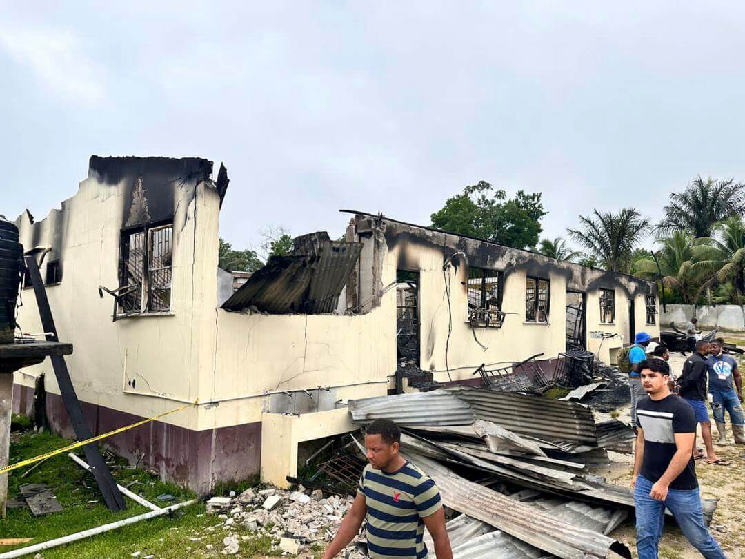 In this photo provided by Guyana's Department of Public Information, the dormitory of a secondary school is burned in Mahdia, Guyana, Monday, May 22, 2023. A nighttime fire raced through the dormitory early Monday, killing at least 20 students and injuring several others, authorities said.