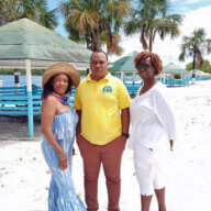From Left, New Yorker Claire, Marketing Manager of Lake Mainstay Resort, Roy Moore, and Brooklyn resident Gillian pose on the white sandy beach of Lake Mainstay/Whyaka Resort, Essequibo county.