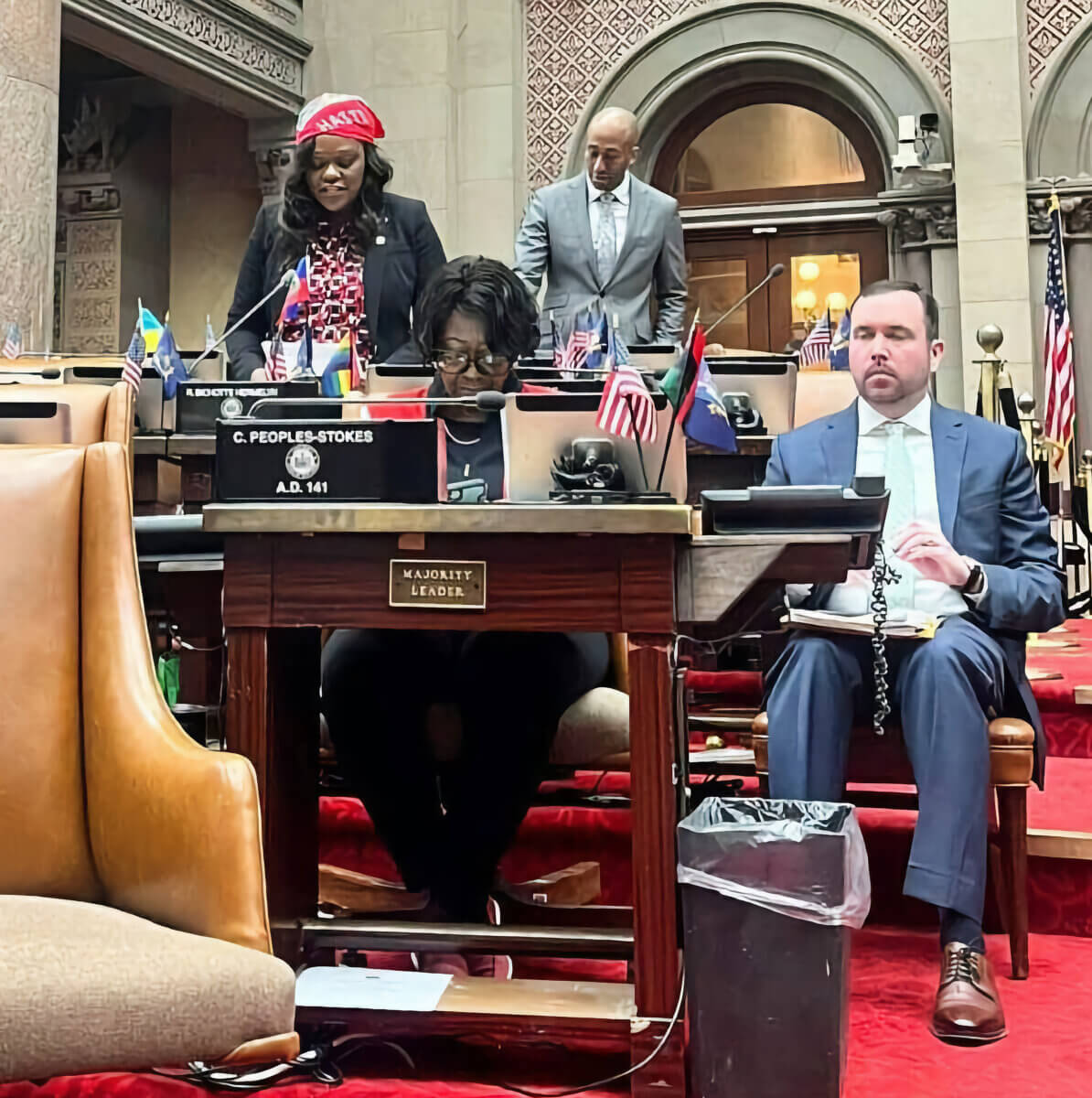 Assemblymember Bichotte Hermelyn speaking on Haitian Heritage Month at the NYS Assembly, with Assembly Majority Leader Crystal D. Peoples-Stokes and Assemblymember Clyde Vanel [a fellow Haitian-American lawmaker].