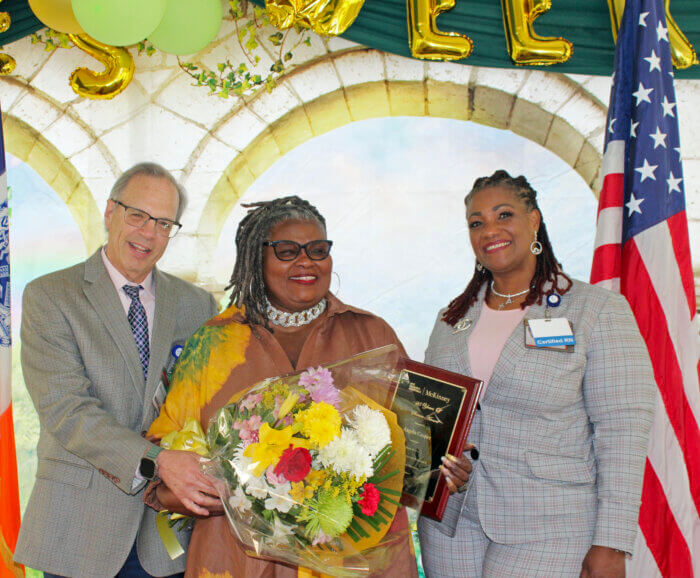 David Weinstein, chief executive officer, Angela Cooper, assistant director, Communications, recipient of the 25 Years of Service Award, and Ann Whyte Akinyooye, chief nursing officer, during the National Nursing Award Ceremony, in McKinney's garden.