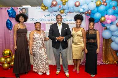 Graduating students strike a pose with Senator Kevin Parker, center after picking out their pretty Prom dresses, shoes and accessories.