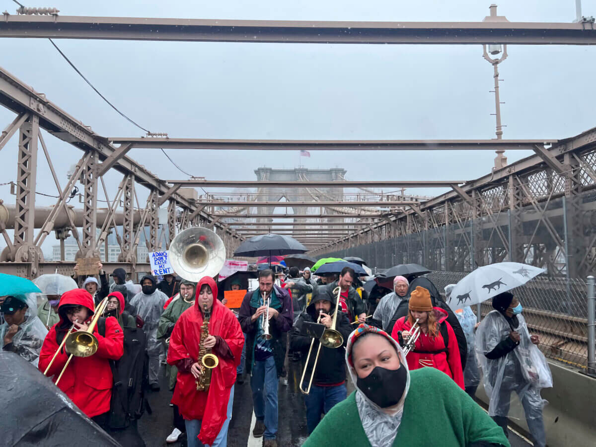 Tenants and housing advocates march over the Brooklyn Bridge to protest high rents.