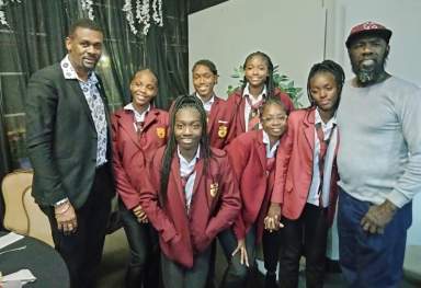St. Vincent and the Grenadines Consul General to the United States Rondy "Luta" McIntosh, left, with James Cordice, right, and athletes from the Thomas Saunders Secondary School in St. Vincent and the Grenadines. 
