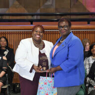 Sen. Roxanne J. Persaud (left) presents Brooklyn’s Lucina Clarke with the NYS Senate Woman of Distinction Award.