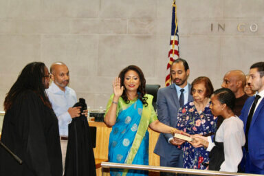 Judge Andrea Ogle, (hand raised center) being inducted as Judge of the Civil Court of the City of New York, by Honorable Judge Edwina Richardson-Mendelson, far left, surrounded by Ivy Ogle, Nigel Ogle, Dr. Kevin Ogle, Adreena Ogle-Crawford, Alexander Ogle, Dr. William Ogle, in Queens County Civil Court, on Sutphin Boulevard, on Friday, 16, 2023.