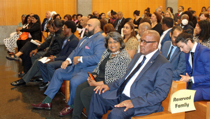 A part of the packed audience during the induction ceremony of Andrea Sabita Ogle, Judge of the Civil Court of the City of New York. CG. Michael E. Brotherson, Gennie Persaud, community leader, and Attorney Ali Najmi in the front row.