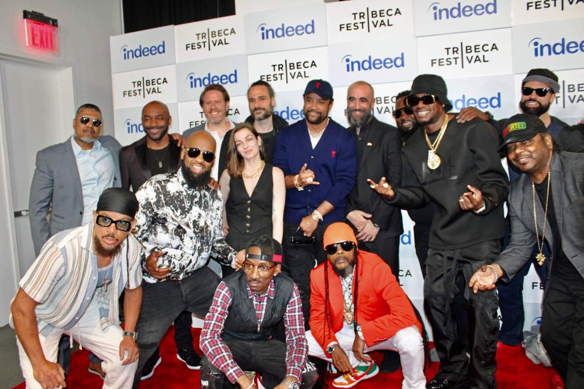 The cast and crew on the Red Carpet at the world premiere of “Bad Like Brooklyn” at the Tribeca Festival, pose for Caribbean Life before the premiere of the documentary film. Executive Producer, Saggy, fifth from left back row, is next to Amy DiGiacomo, producer, and surrounded by other cast members.