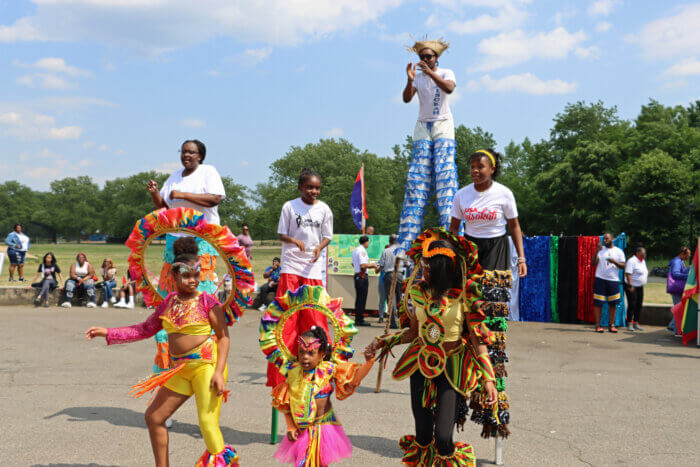 Stilt dancers with Caribbean dancers perform in Carnasie Park.