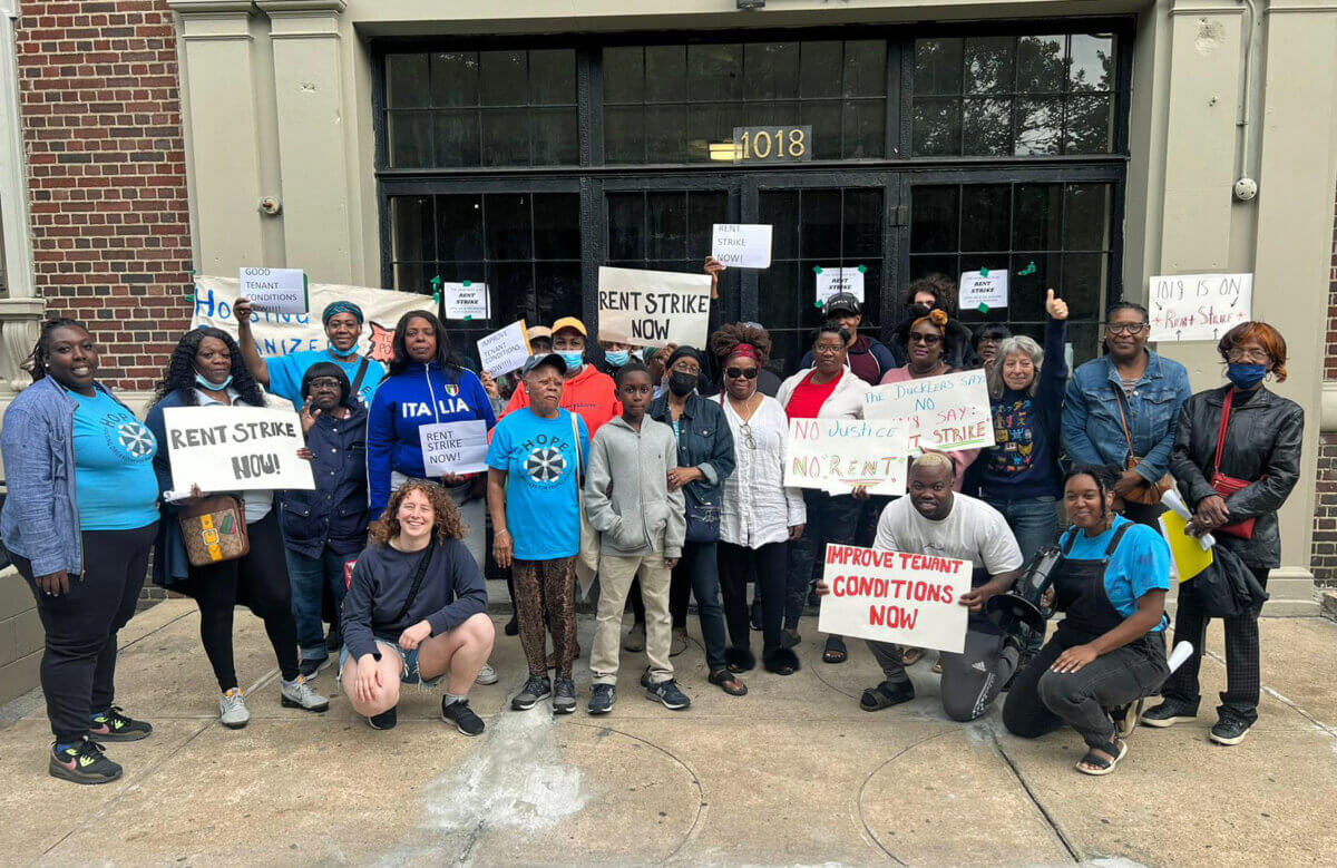 A group photo at the end of the Dukler Rent Strike Rally for tenants of Rubin Dukler. Tenants from 1018 & 1074 Eastern Parkway and 1392 Sterling Place stand alongside members of Housing Organizers for People Empowerment (HOPE), people in the neighborhood, members of the Housing Justice for All coalition, staff from UHAB (Urban Homesteading Assistance Board) and Assemblywoman Latrice Walker.