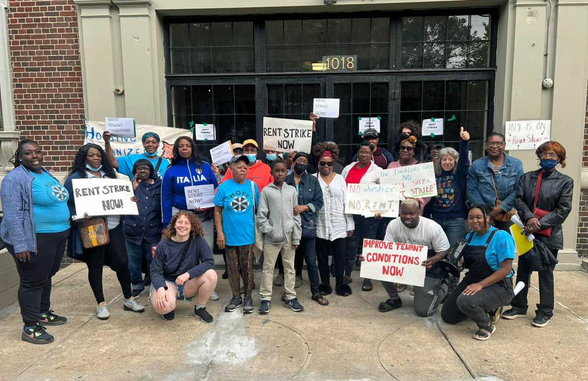 A group photo at the end of the Dukler Rent Strike Rally for tenants of Rubin Dukler. Tenants from 1018 & 1074 Eastern Parkway and 1392 Sterling Place stand alongside members of Housing Organizers for People Empowerment (HOPE), people in the neighborhood, members of the Housing Justice for All coalition, staff from UHAB (Urban Homesteading Assistance Board) and Assemblywoman Latrice Walker.