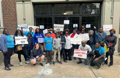 A group photo at the end of the Dukler Rent Strike Rally for tenants of Rubin Dukler. Tenants from 1018 & 1074 Eastern Parkway and 1392 Sterling Place stand alongside members of Housing Organizers for People Empowerment (HOPE), people in the neighborhood, members of the Housing Justice for All coalition, staff from UHAB (Urban Homesteading Assistance Board) and Assemblywoman Latrice Walker.