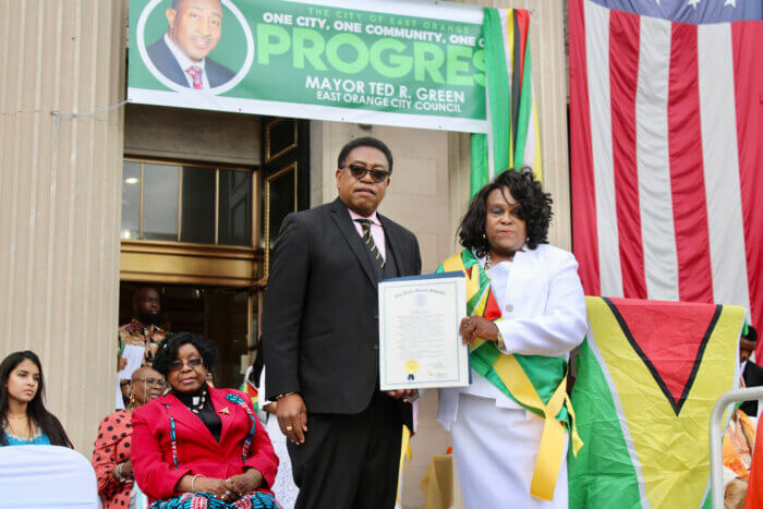 Dr. Terrence Blackman, Medgar Evers professor, keynote speaker at Guyana's 57th Anniversary of Independence being presented with the Trailblazer Award from Lady Ira Lewis at the East Orange City Hall Plaza, NJ.