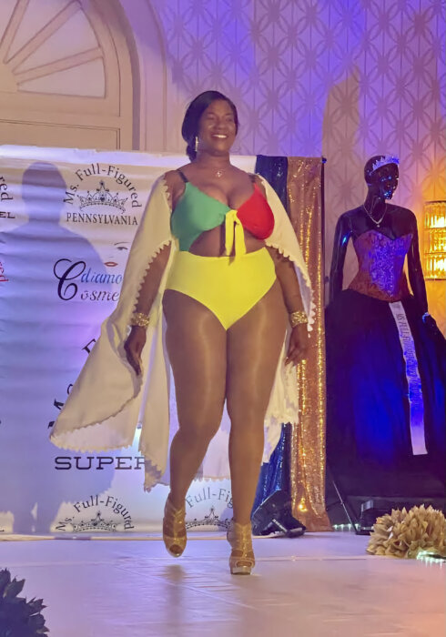 Guyanese-born Natasha V. Dickson-Rudder who was crowned Ms. full-figured USA PA Swimwear 2023 on the runway in her winning swimwear designed with the colors of Guyana's Golden Arrowhead flag.