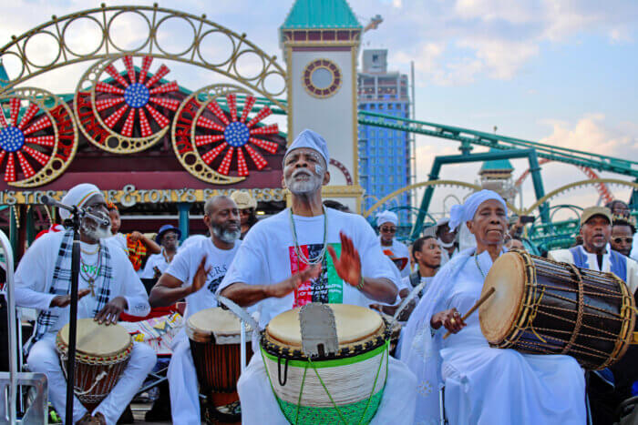 Menes de Griot and Mama Naya on stage with the drumming circle at the 34th Annual Tribute to the Ancestors on the Coney Island boardwalk.