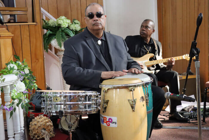 Baba Dow Eaton on drums, with guitarist Kelvin Burke in background.