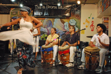 Members of Alma Moyo band, featuring Oxil Febles dancing (front). On drums Manuela Arciniegas, Nelson Cabassa, Ariel LaSalle.  Behind Febles: Alex LaSalle and Ines Mangual. 
