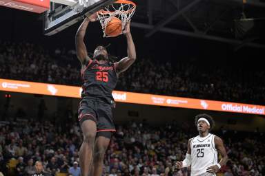 Houston forward Jarace Walker, left, dunks in front of Central Florida forward Taylor Hendricks, right, during the first half of an NCAA college basketball game Jan. 25, 2023, in Orlando, Fla. Walker is among the top forwards in the upcoming NBA draft.