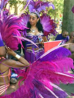 A reveler decked out in a colorful costume at Lincoln Park, Jersey City in preparation to play mas at the Jersey City Caribbean Carnival in 2016.