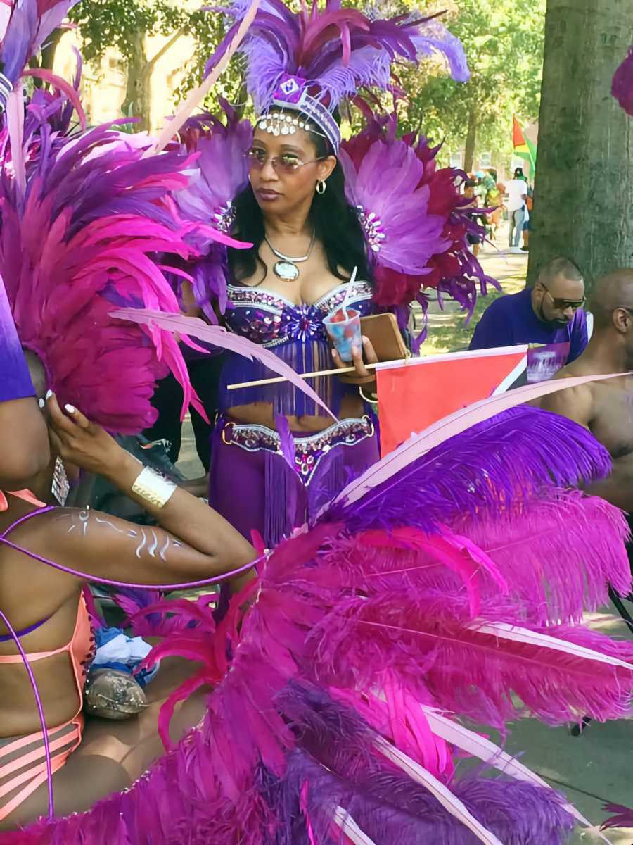 A reveler decked out in a colorful costume at Lincoln Park, Jersey City in preparation to play mas at the Jersey City Caribbean Carnival in 2016.