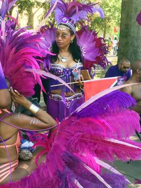 A reveler decked out in a colorful costume at Lincoln Park, Jersey City in preparation to play mas at the Jersey City Caribbean Carnival in 2016.