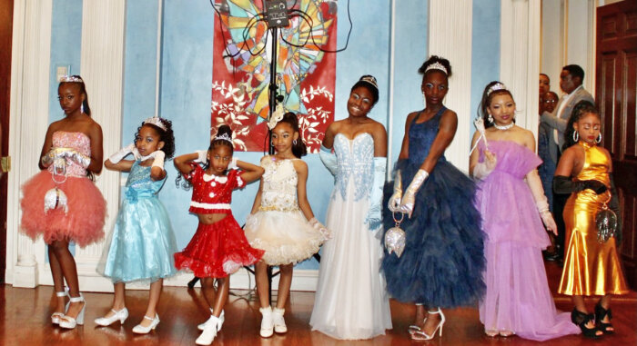 Eleven-year-old Amirah Homes, far left, posing with models wearing her AQ Wear Qumara Boutique collection.
