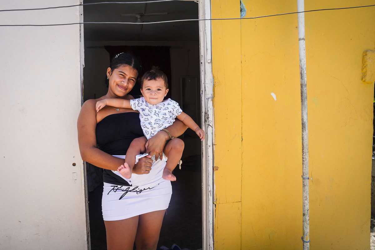 Nirma with her 8 months baby at the entrance of her home in Will