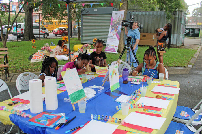 Youths enjoy a painting on canvas exercise at 16th Annual Back-to-School Harvest Fest hosted by Sen.Kevin Parker at Paerdegat Park, in the 21st Senate District, Brooklyn on Aug. 26, 2023.