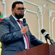 President Mohamed Irfaan Ali addresses nationals at a diaspora town hall meeting at the Hotel Liberty Inn & Suites in Queens.
