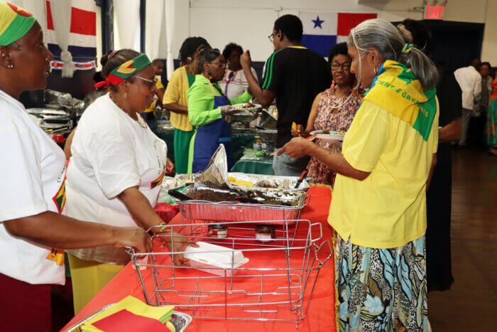 Participants getting a dish at the Grenada stall.