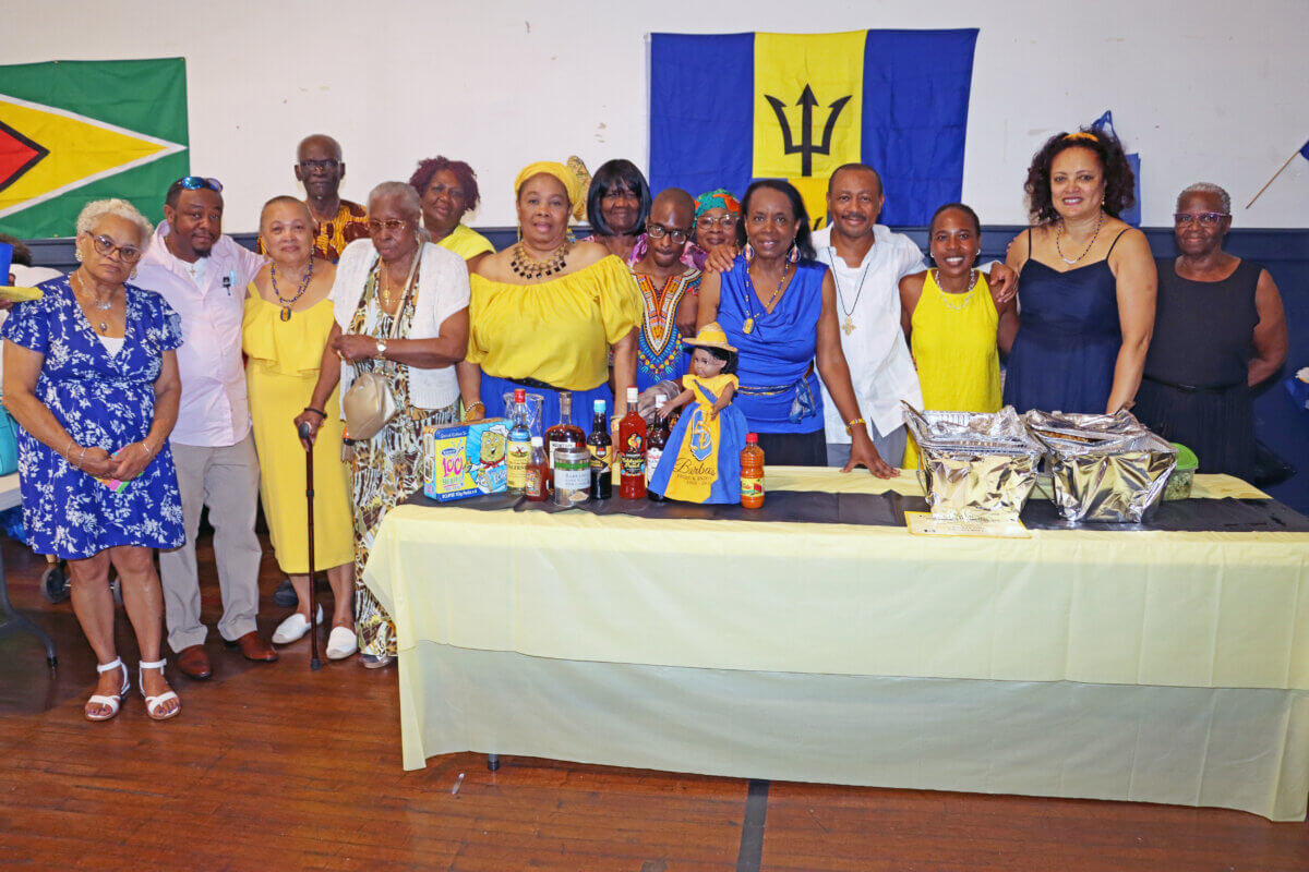 Fr. Sheldon Hamblin, eighth from left, at the Barbados table.