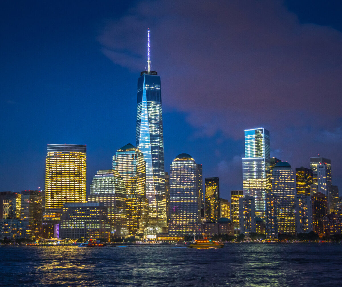 Skyline of lower Manhattan New York City at night with World Trade Center at full height. Viewed from the Hudson River in Jersey City New Jersey.