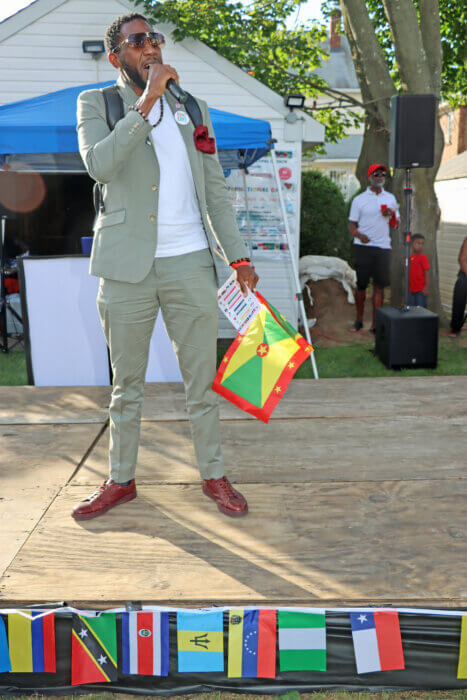 Public Advocate Jumaane Williams, with Grenadian flag, addresses the ceremony.